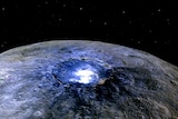 A close up view of  the dwarf planet Ceres showing the Occator Crater and its mysterious bright spots.