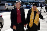 The Archbishop of Perth Roger Herft arrives at court with a supporter.
