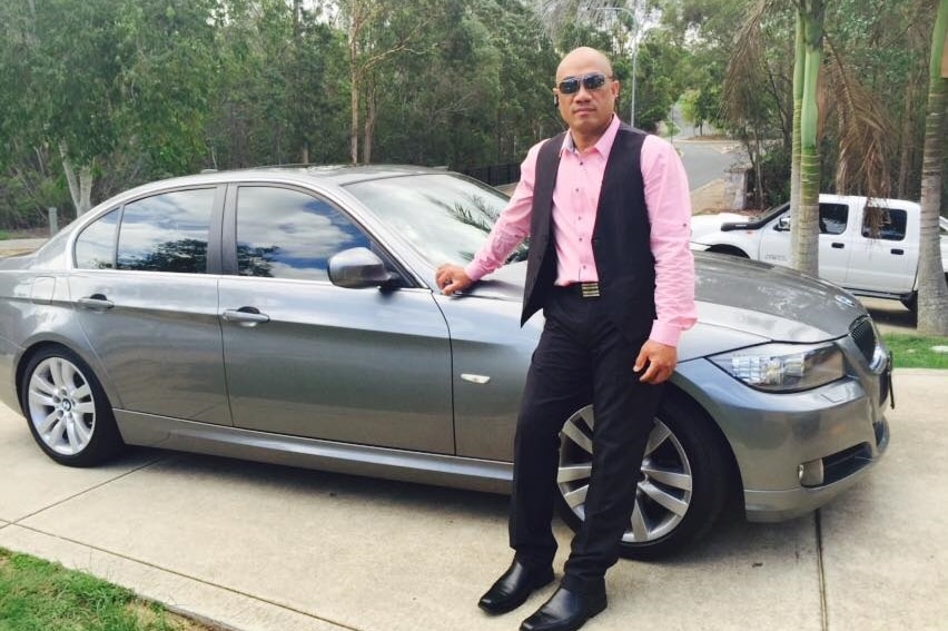 Sakaria Taufao, standing next to a silver car.