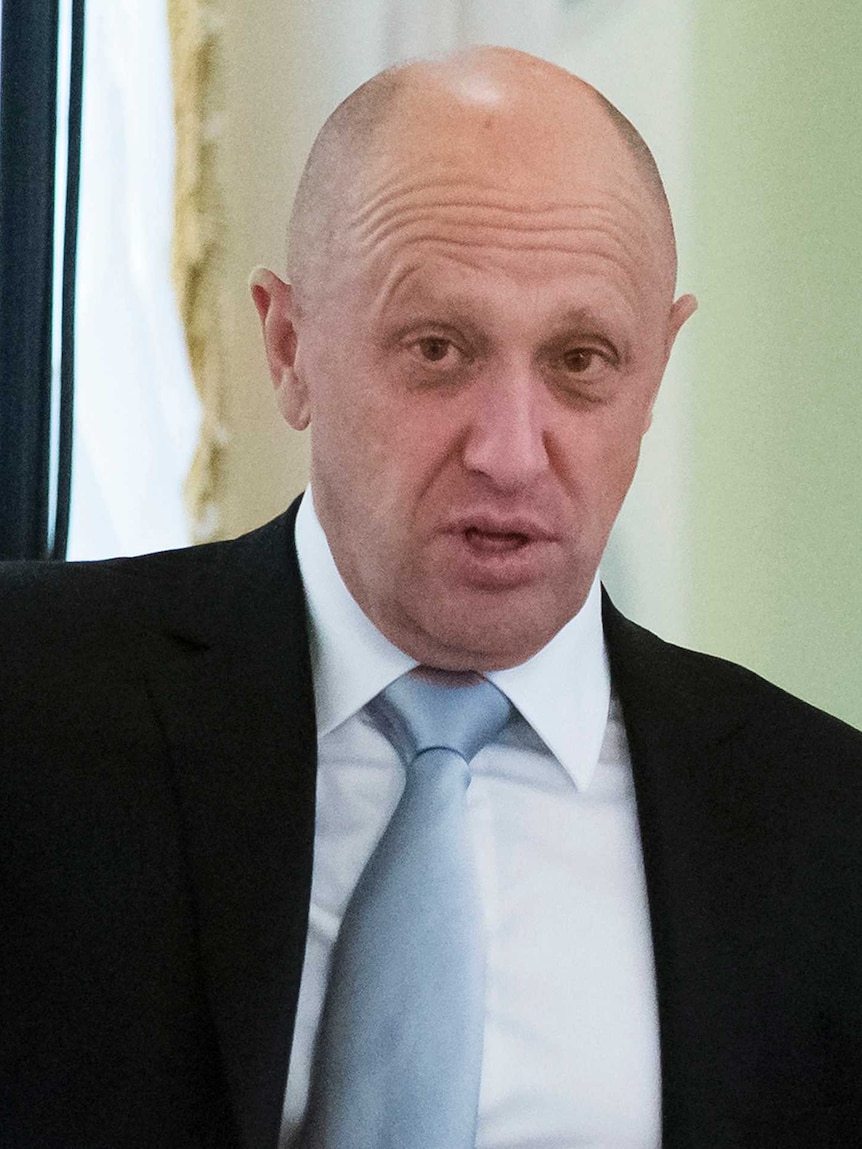 Yevgeny Prigozhin points his finger, his gaze his slightly past the camera