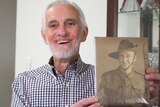 Peter Corey with a photo of his father Jack Corey.