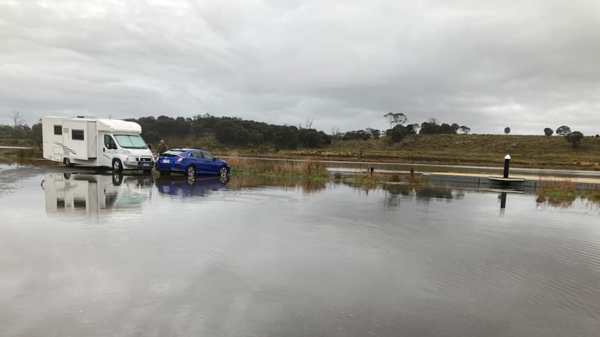 Caravan and car in floodwaters.