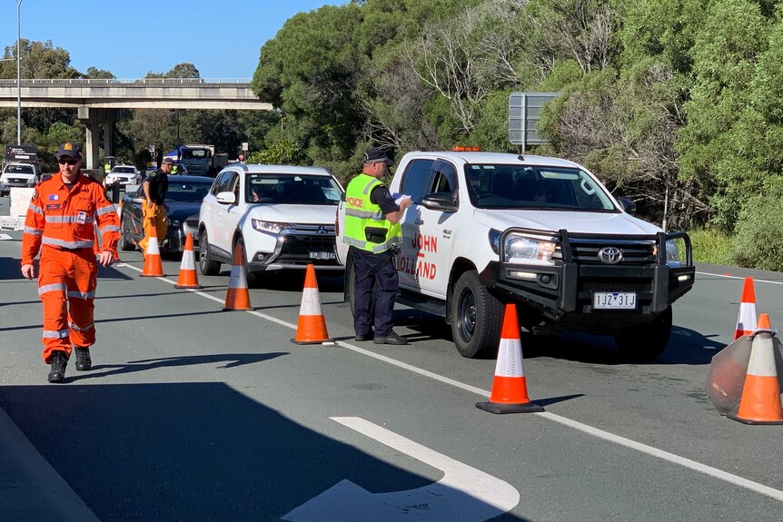 Police conduct checks on motorists on the Gold Coast Highway at the Queensland-NSW border.