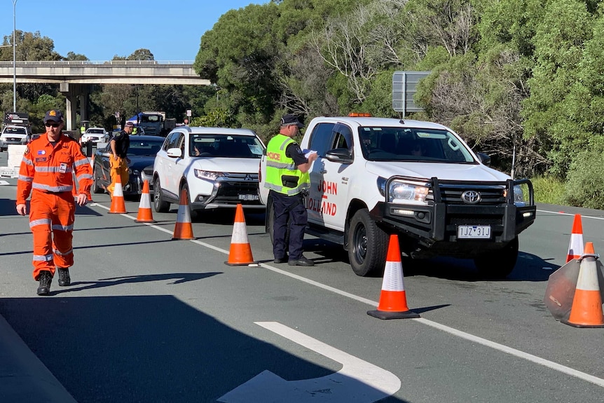 Police conduct checks on motorists on the Gold Coast Highway at the Queensland-NSW border.