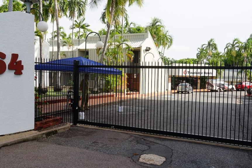 The exterior of a motel building in Darwin surrounded by trees.