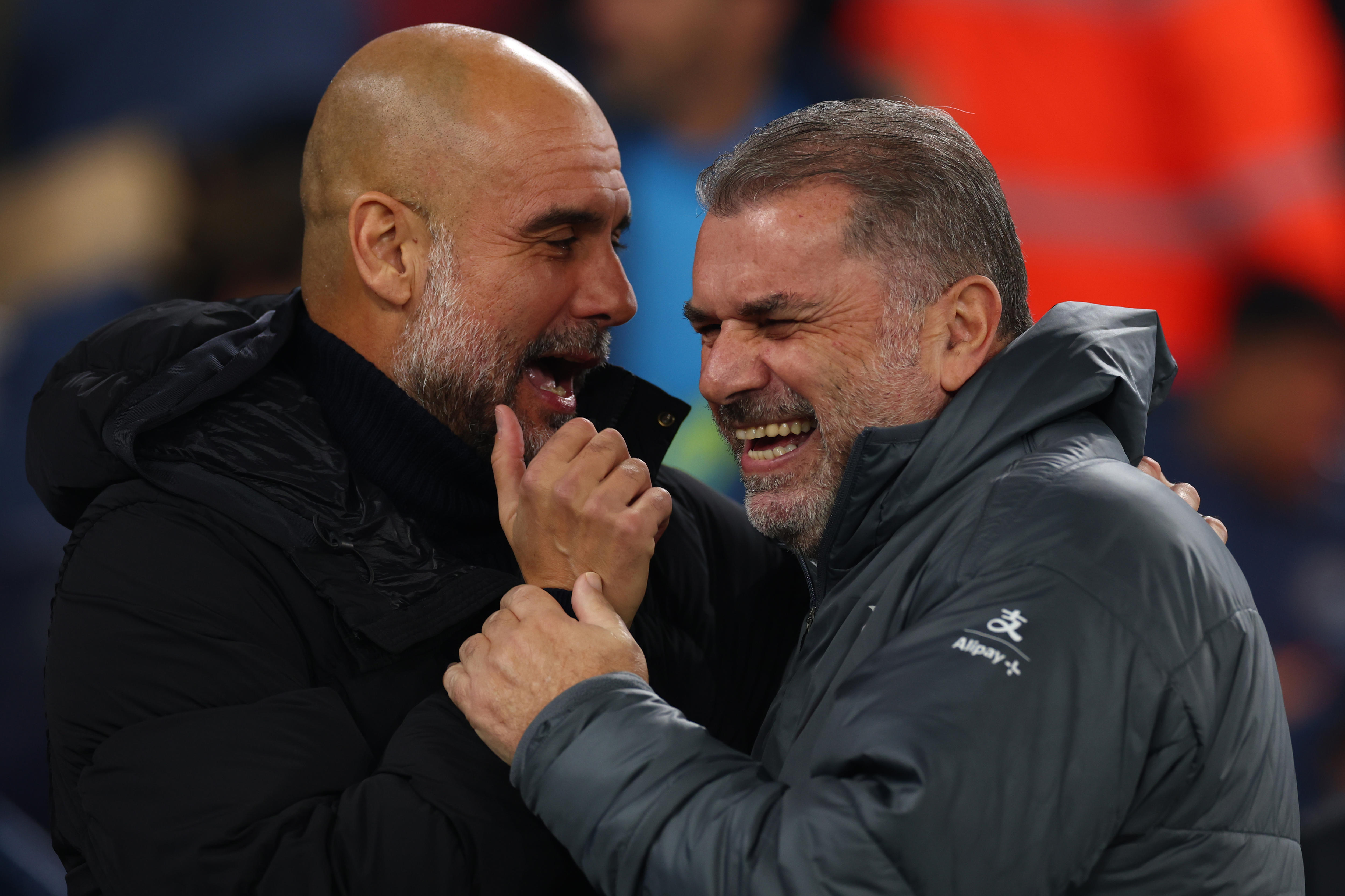 Two Prem ier League managers laugh together on the sidelines before a big match.