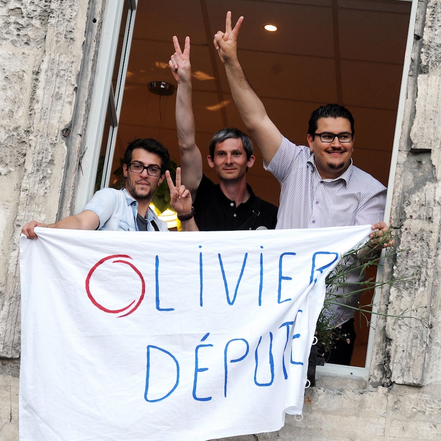 Supporters of Olivier Falorni wave a banner after the French parliamentary elections.