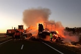 Hay on truck engulfed in flames between kynuna and winton being sprayed by water by Queensland Fire Service