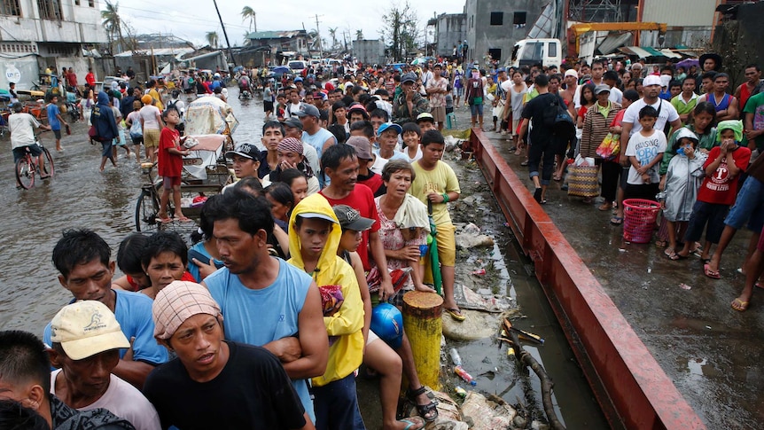 Typhoon survivors queue for food in Tacloban on November 12, 2013