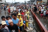 Typhoon survivors queue for food in Tacloban on November 12, 2013