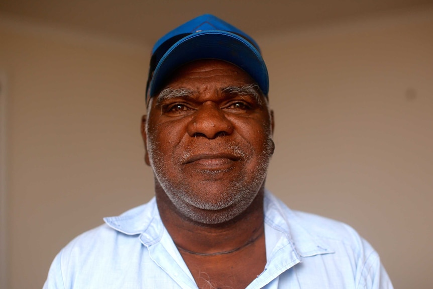 Norman Frank wears a blue cap and white shirt.