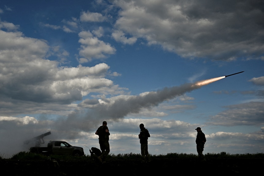 Ukrainian servicemen fire a Partyzan multiple launch rocket system.