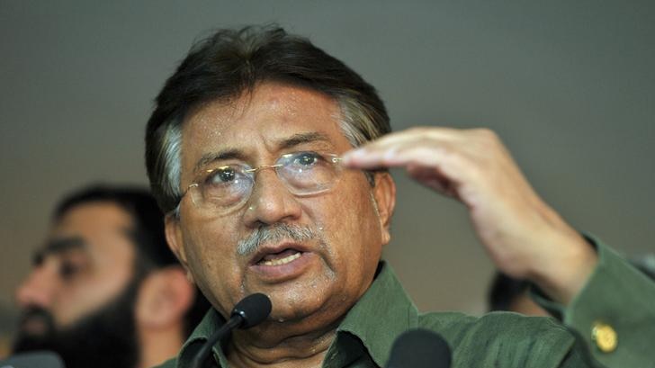 Pervez Musharraf, wearing a green shirt, gestures while speaking at a conference.