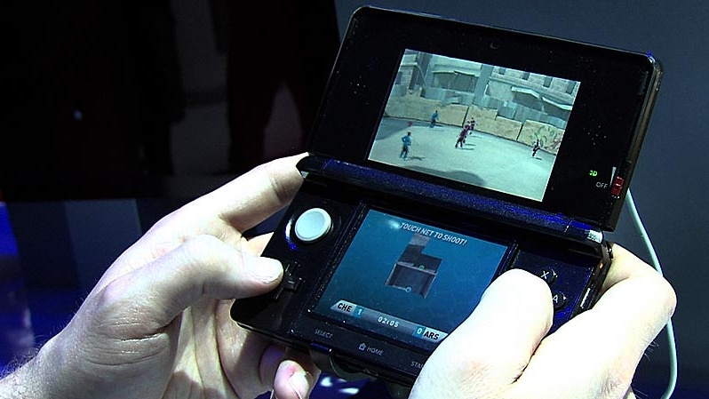 A gamer plays a Nintendo 3DS console.