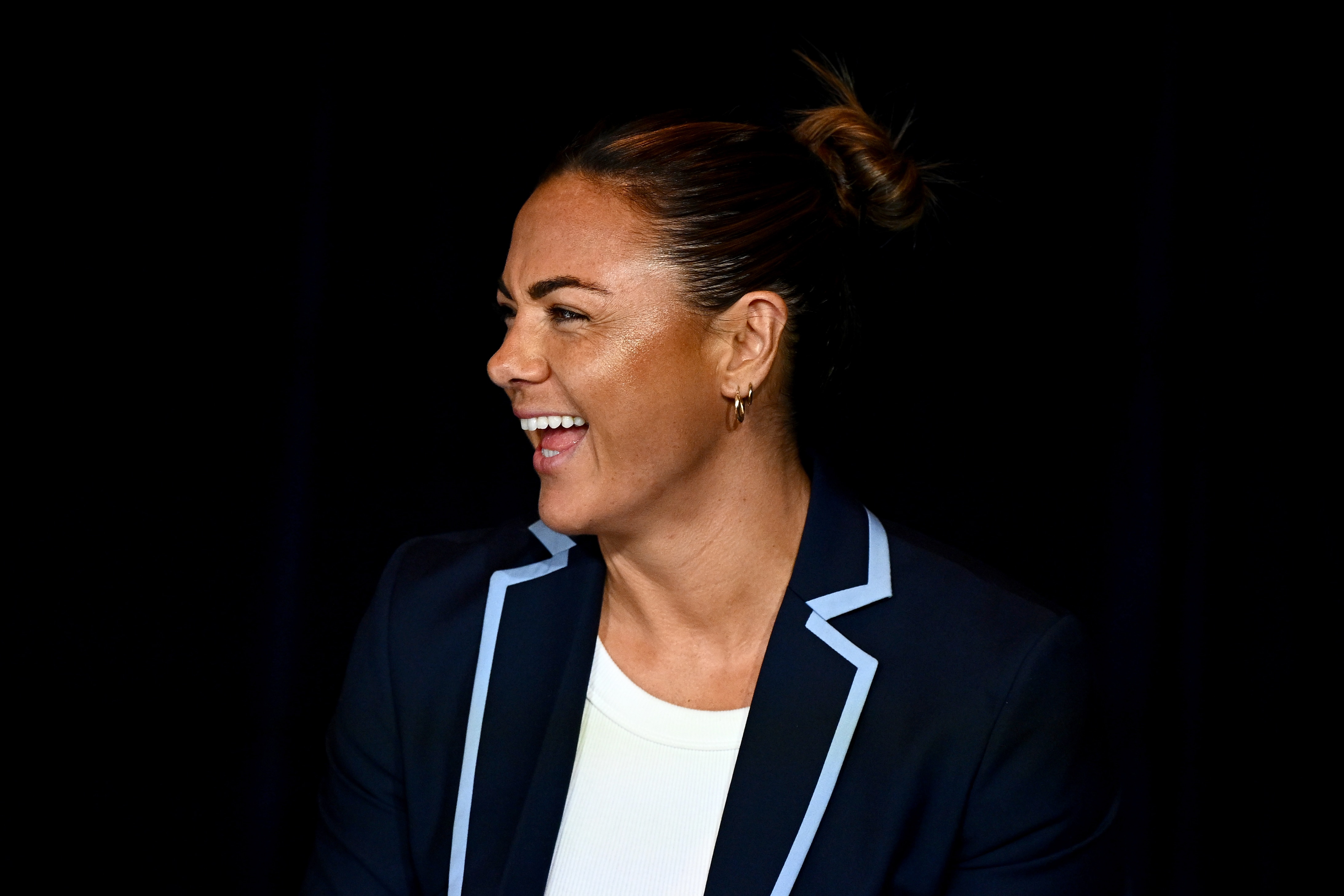 Millie Elliott smiles in a blazer