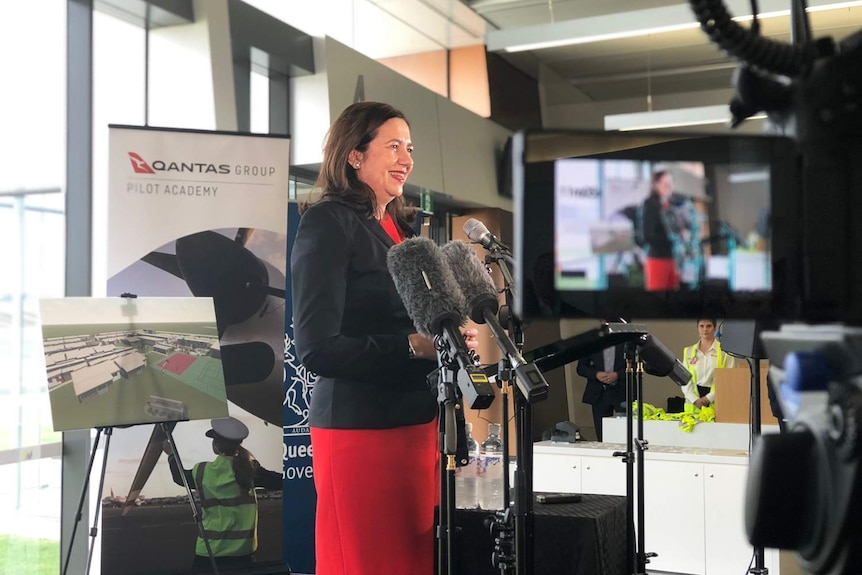 Queensland Premier Annastacia Palaszczuk stands in front of media at Wellcamp Airport.