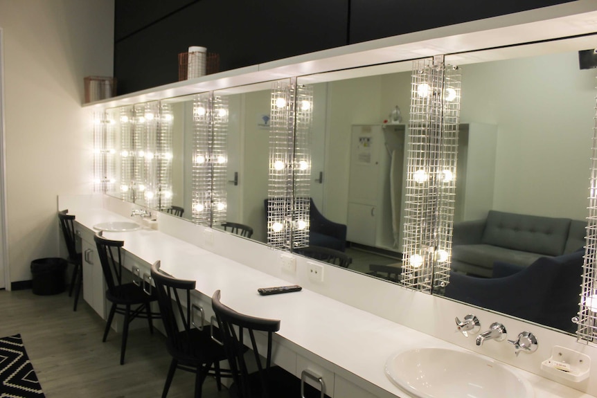 Chairs, lights and mirrors inside a dressing room at QPAC.
