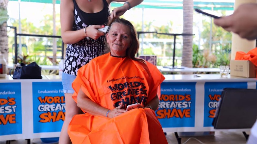 a woman about to have hair shaved off