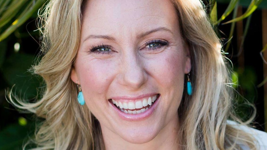 Justine Damond smiles while posing for a photo.