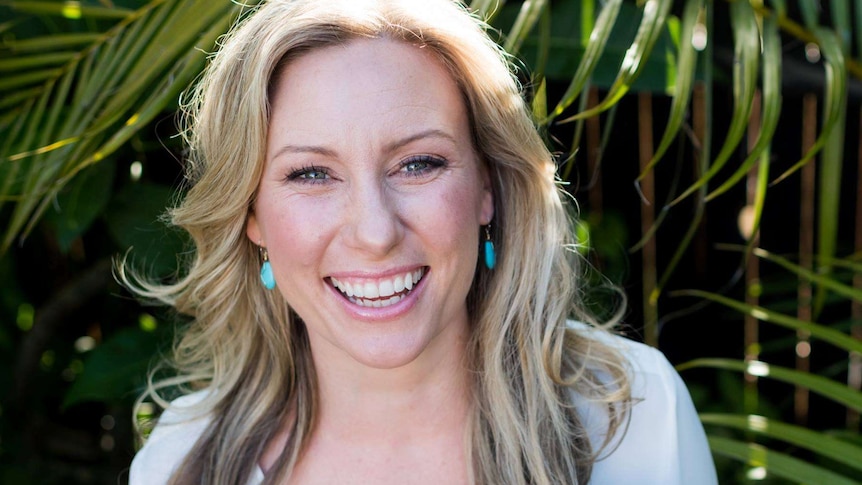 A blonde woman smiling for the camera