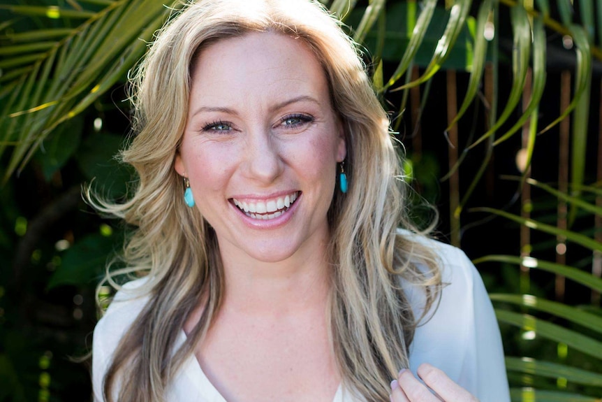 A blonde woman smiling for the camera