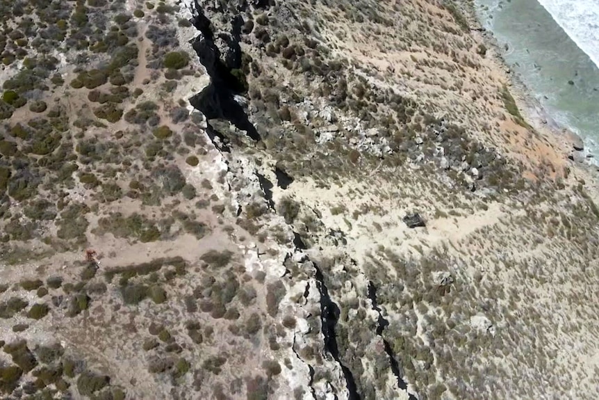 An aerial shot of a steep rocky cliff face