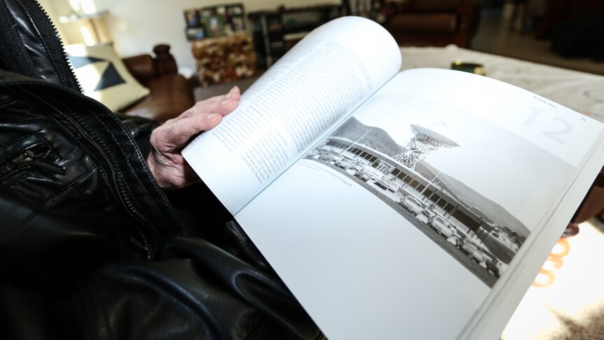 An open book with a picture of the Orroral Valley Tracking Station.