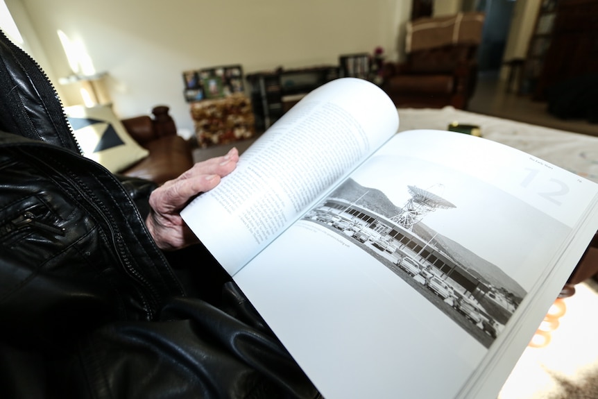 An open book with a picture of the Orroral Valley Tracking Station.