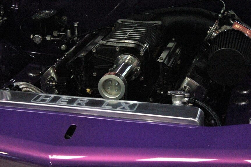 A flash looking engine on a purple car.