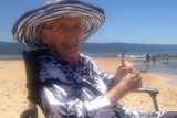 Shirley Fowler sits in a wheelchair at the beach.