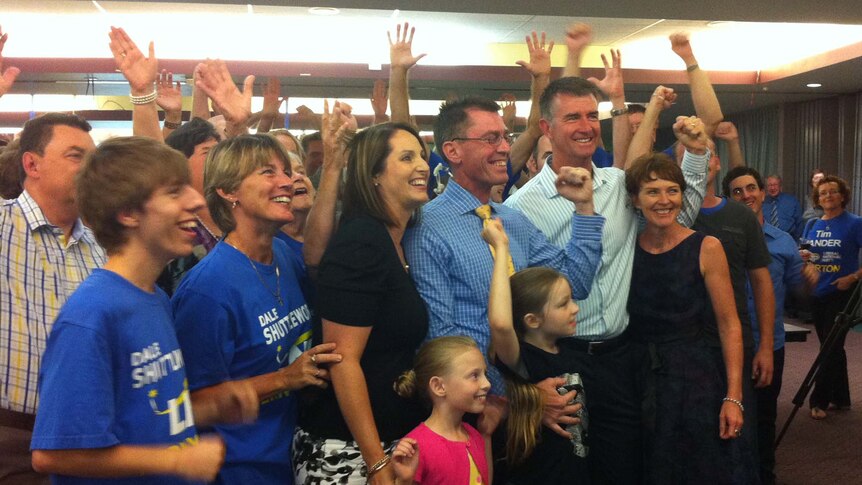 Dale Shuttleworth (centre) celebrates with supporters after winning the Brisbane seat of Ferny Grove