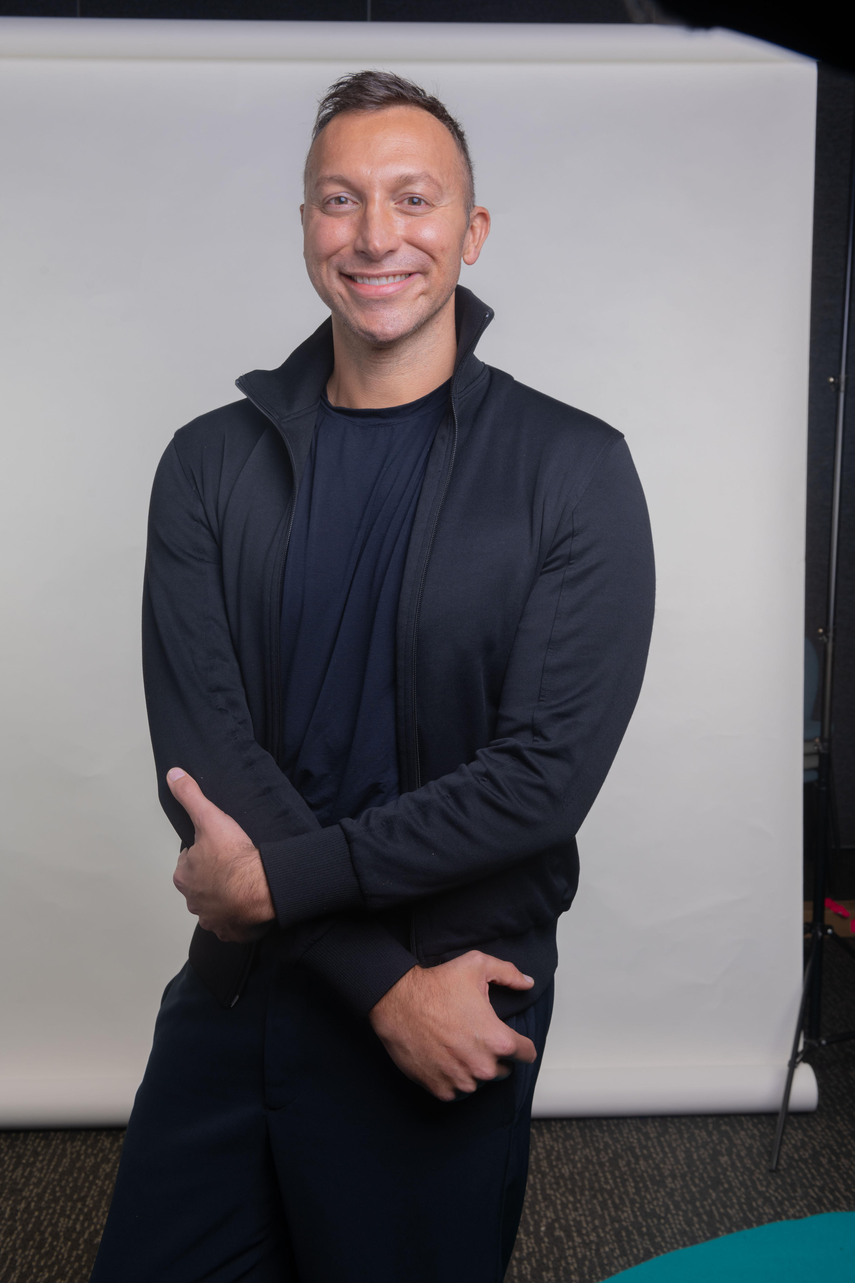 Ian Thorpe smiling with a large geometric window behind him.