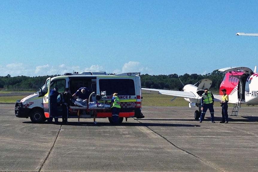 Paramedics treat patient injured in chopper crash.