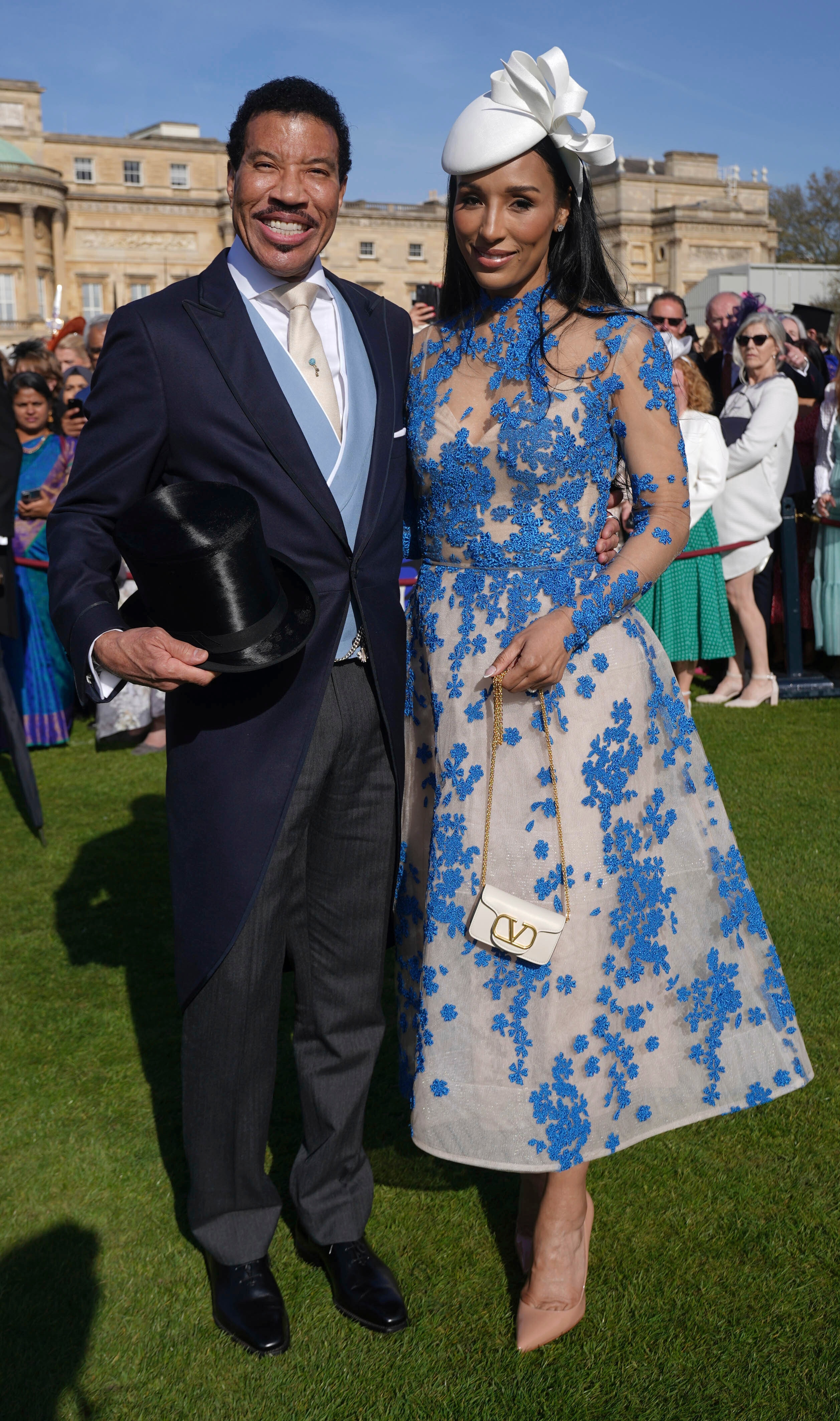 A man standing next to a woman, both smiling to the camera