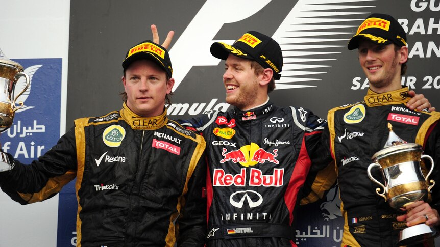 Sebastian Vettel gives Kimi Raikkonen 'rabbit ears' on the podium in Bahrain.
