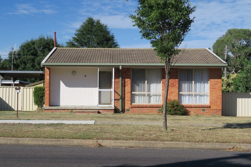 An ex-government house viewed from the street in Canberra.