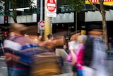 A artfully blurry photo of people crossing a busy intersection.