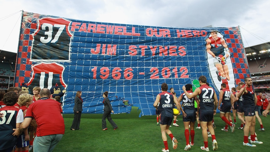 Farewell our hero ... the Demons unfurl a banner in memory of Jim Stynes.