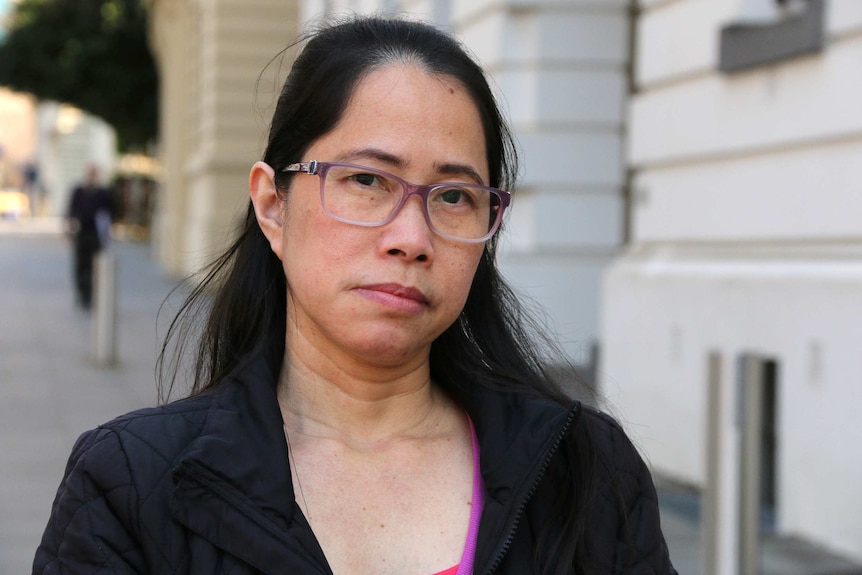 Filipino student Leilani Dajalos stands on a street, looking into the camera.