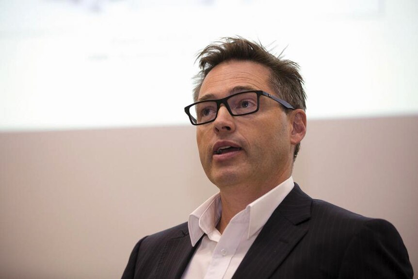 Headshot of a man in glasses.