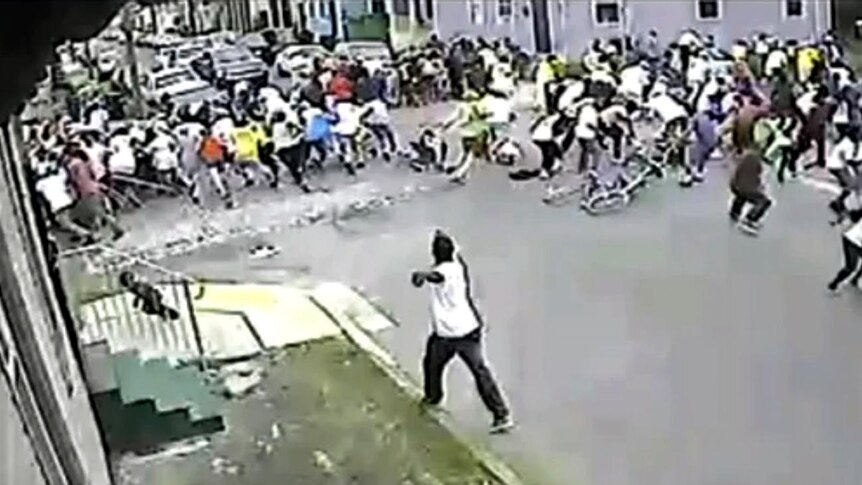 A person appears to fire a gun into the crowd at a Mother's Day parade in New Orleans.
