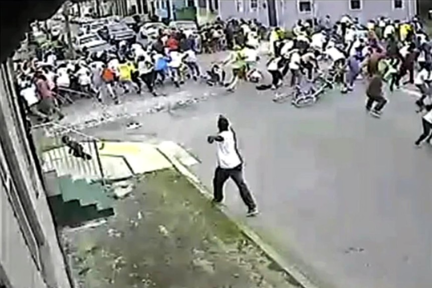 A person appears to fire a gun into the crowd at a Mother's Day parade in New Orleans.