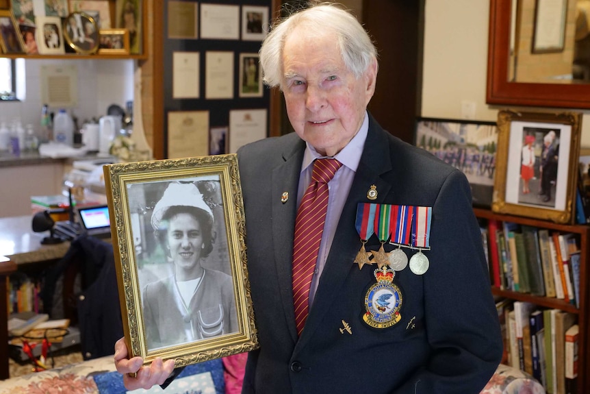 Bruce Robertson holds a portrait of his wife Beryl.