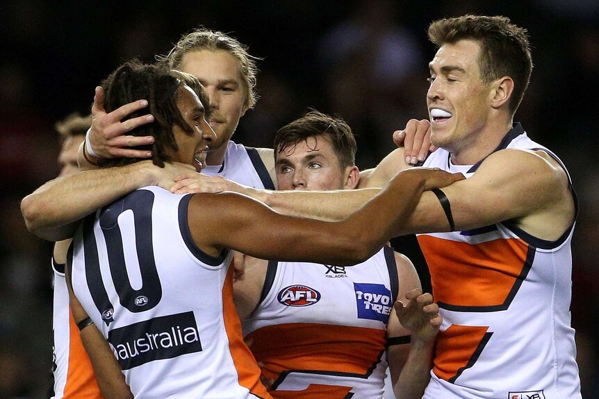 The Giants' Aiden Bonar (L) celebrates his first AFL goal against Carlton at Docklands.