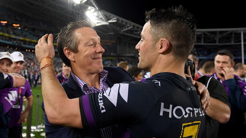 Craig Bellamy and Cooper Cronk hug each other after the 2017 NRL grand final.