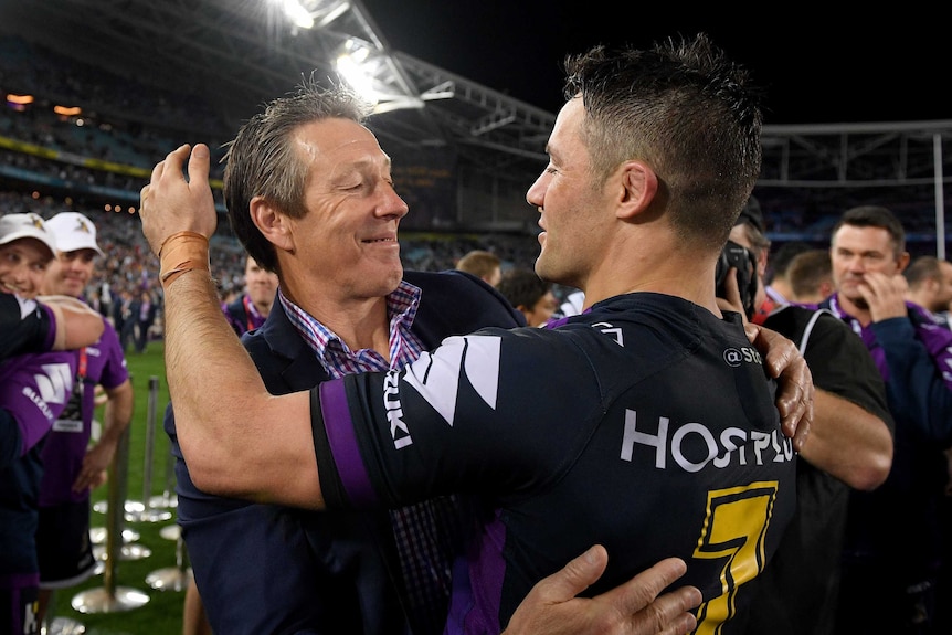 Craig Bellamy and Cooper Cronk hug each other after the 2017 NRL grand final.