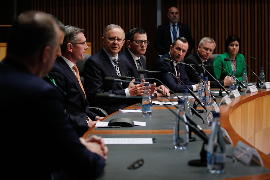 State and territory leaders sit in a row at a curved desk, with Albanese at the centre and others flanking him.