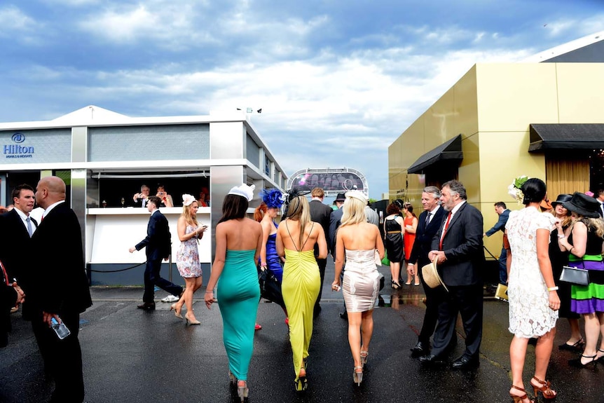 Punters make their way home from Flemington racecourse.