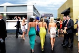Punters make their way home from Flemington racecourse