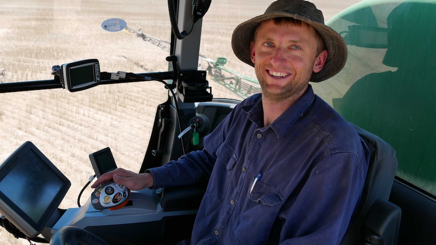 Man in cabin of farm vehicle